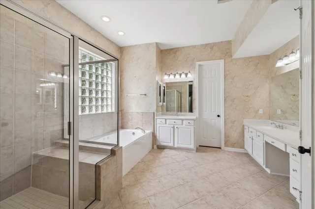 a bathroom with a bathtub and shower