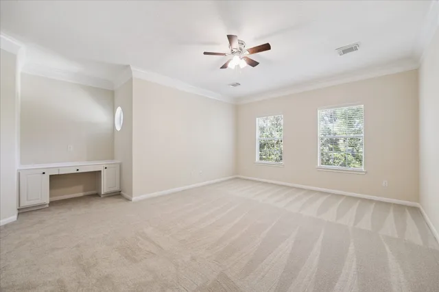 a large white kitchen with stainless steel appliances granite countertop a stove and a large window