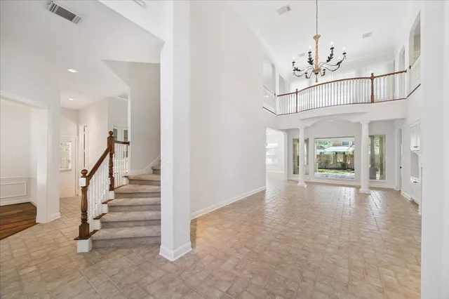 wooden floor in an empty room with a staircase