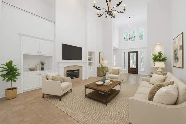 a living room with furniture a fireplace and a potted plant