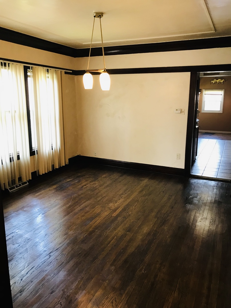 3246 West 65th Street Chicago, IL 60629 - Photo 11 of 50 a view of a room with wooden floor and windows