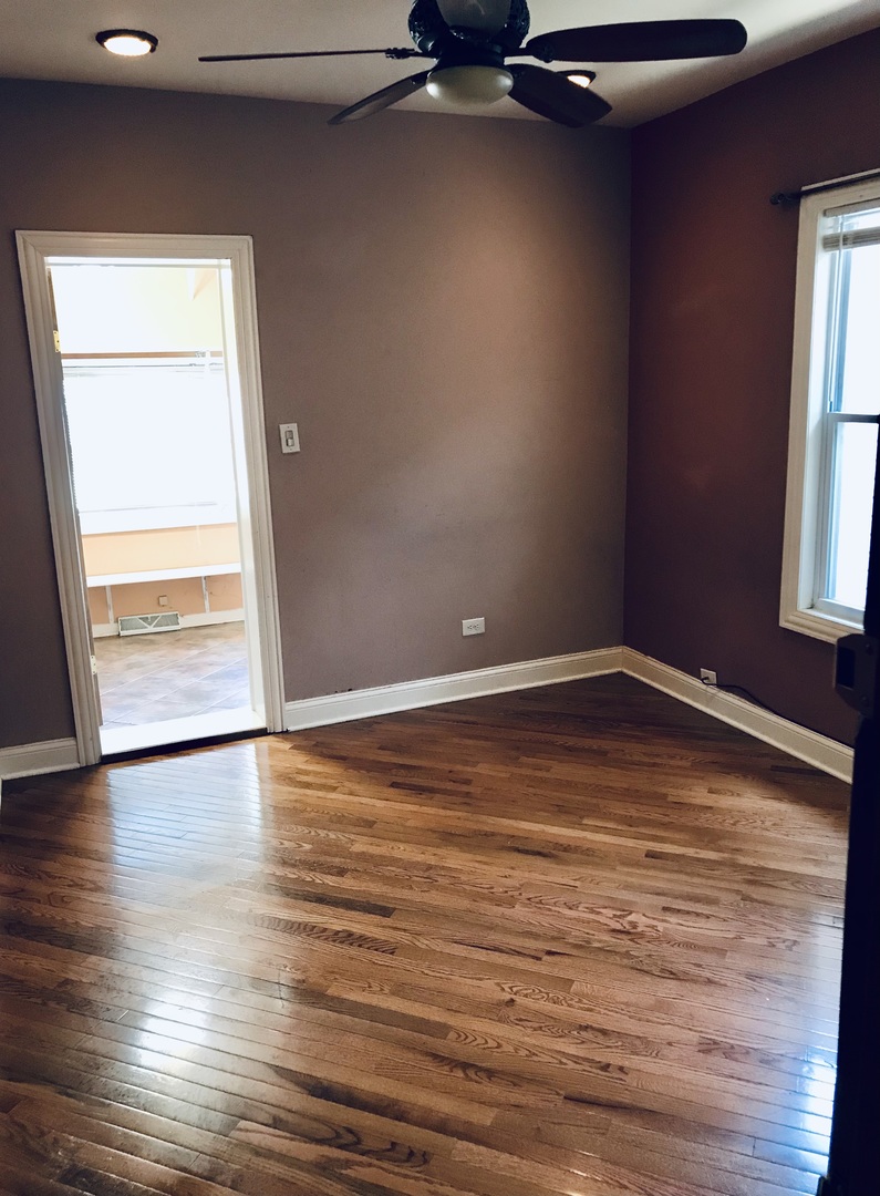 3246 West 65th Street Chicago, IL 60629 - Photo 15 of 50 an empty room with wooden floor and windows