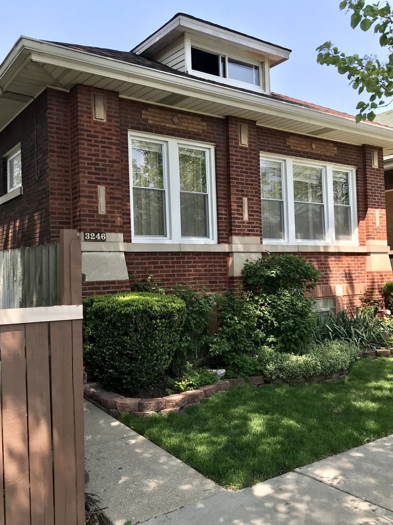 3246 West 65th Street Chicago, IL 60629 - Photo 2 of 50 a front view of a house with a yard
