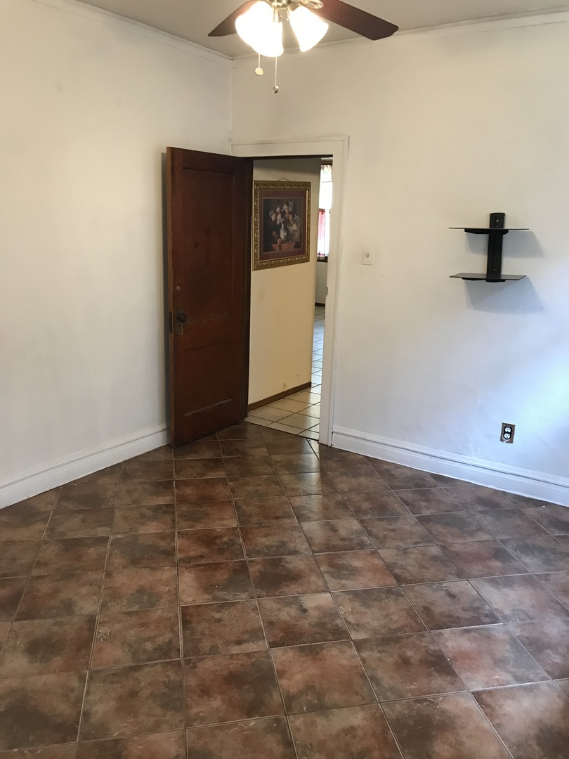3246 West 65th Street Chicago, IL 60629 - Photo 21 of 50 a view of an empty room with a chandelier fan