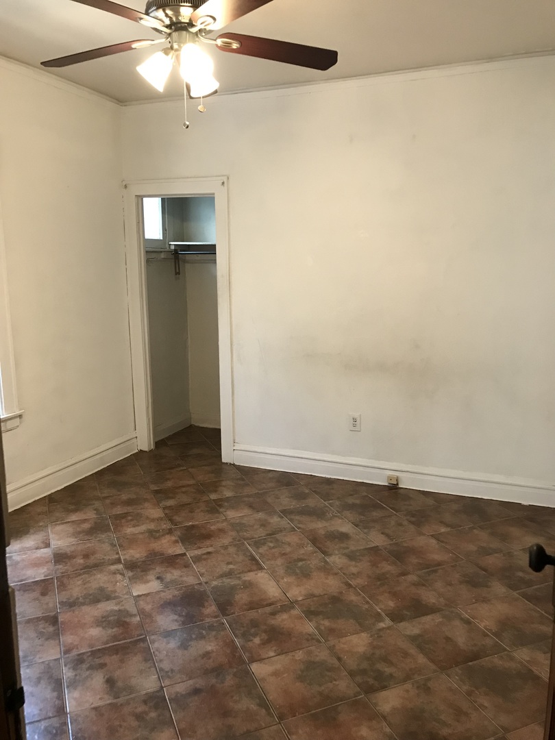 3246 West 65th Street Chicago, IL 60629 - Photo 23 of 50 an empty room with a fan and a fan