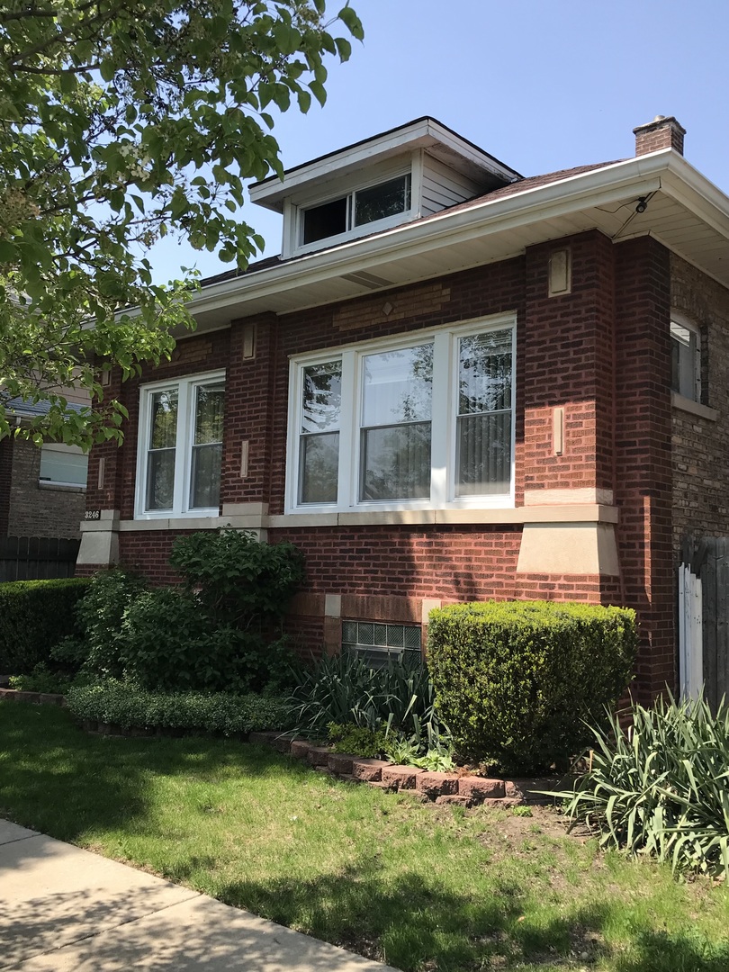 3246 West 65th Street Chicago, IL 60629 - Photo 3 of 50 a front view of a house with a yard