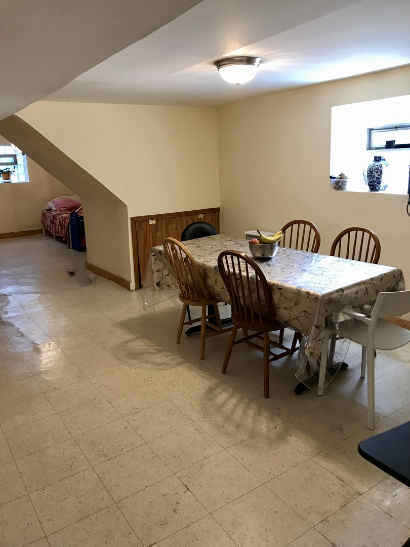 3246 West 65th Street Chicago, IL 60629 - Photo 34 of 50 a dining room with furniture and a chandelier