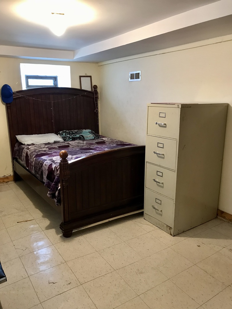 3246 West 65th Street Chicago, IL 60629 - Photo 37 of 50 a bedroom with a bed and cabinets