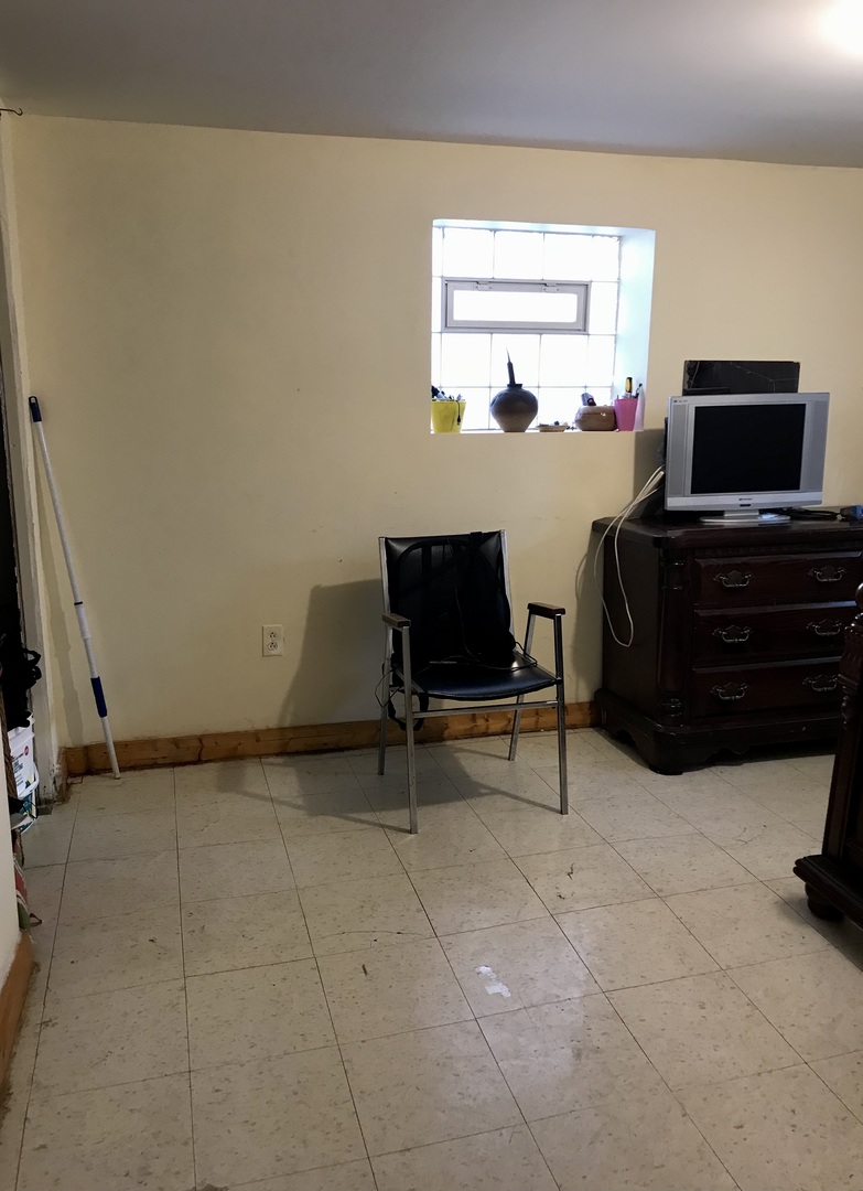 3246 West 65th Street Chicago, IL 60629 - Photo 38 of 50 a living room with furniture a flat screen tv and a window