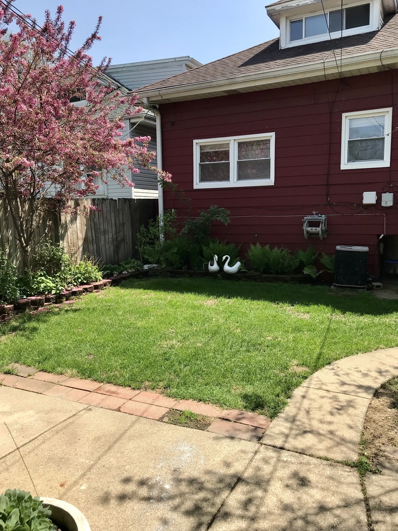 3246 West 65th Street Chicago, IL 60629 - Photo 41 of 50 a front view of a house with a yard