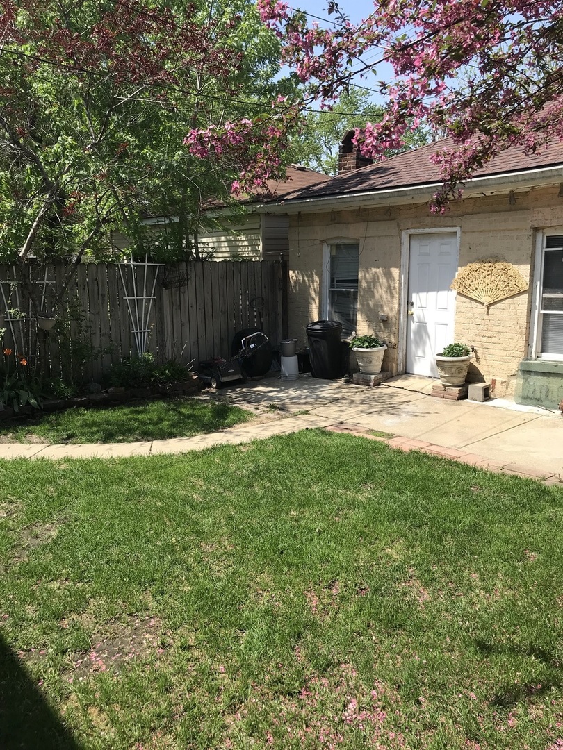 3246 West 65th Street Chicago, IL 60629 - Photo 43 of 50 a view of a chair and table in backyard of the house