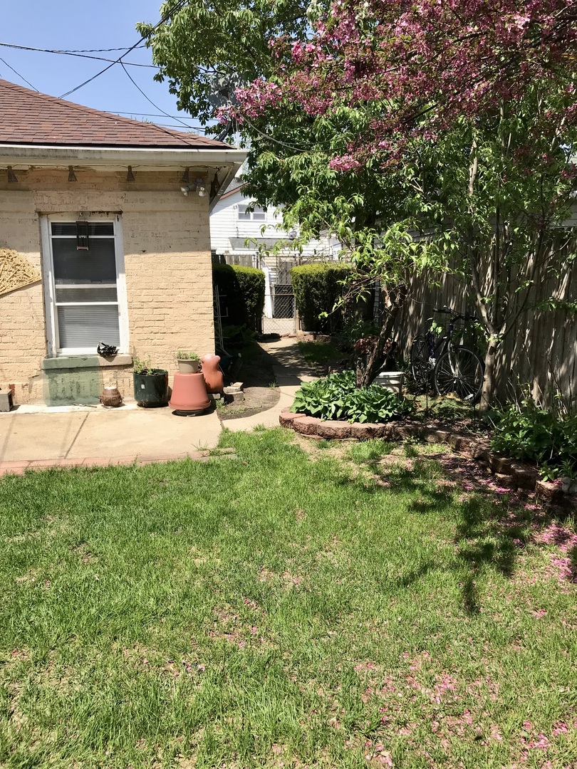 3246 West 65th Street Chicago, IL 60629 - Photo 45 of 50 a front view of a house with a yard