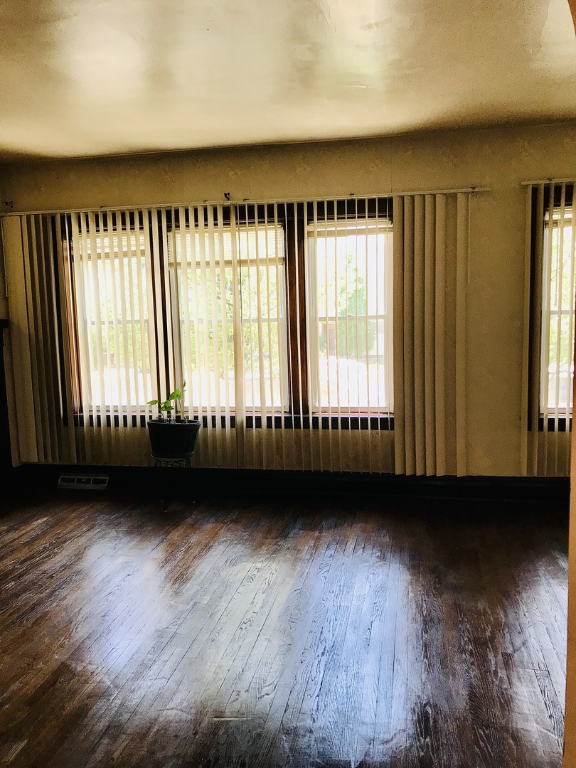 3246 West 65th Street Chicago, IL 60629 - Photo 8 of 50 a view of an empty room with wooden floor and a window