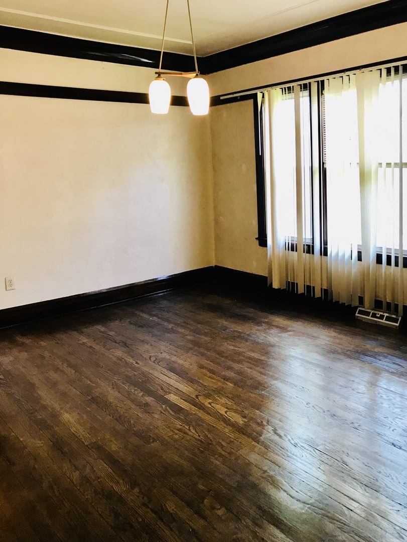 3246 West 65th Street Chicago, IL 60629 - Photo 10 of 50 a view of an empty room with wooden floor and a window