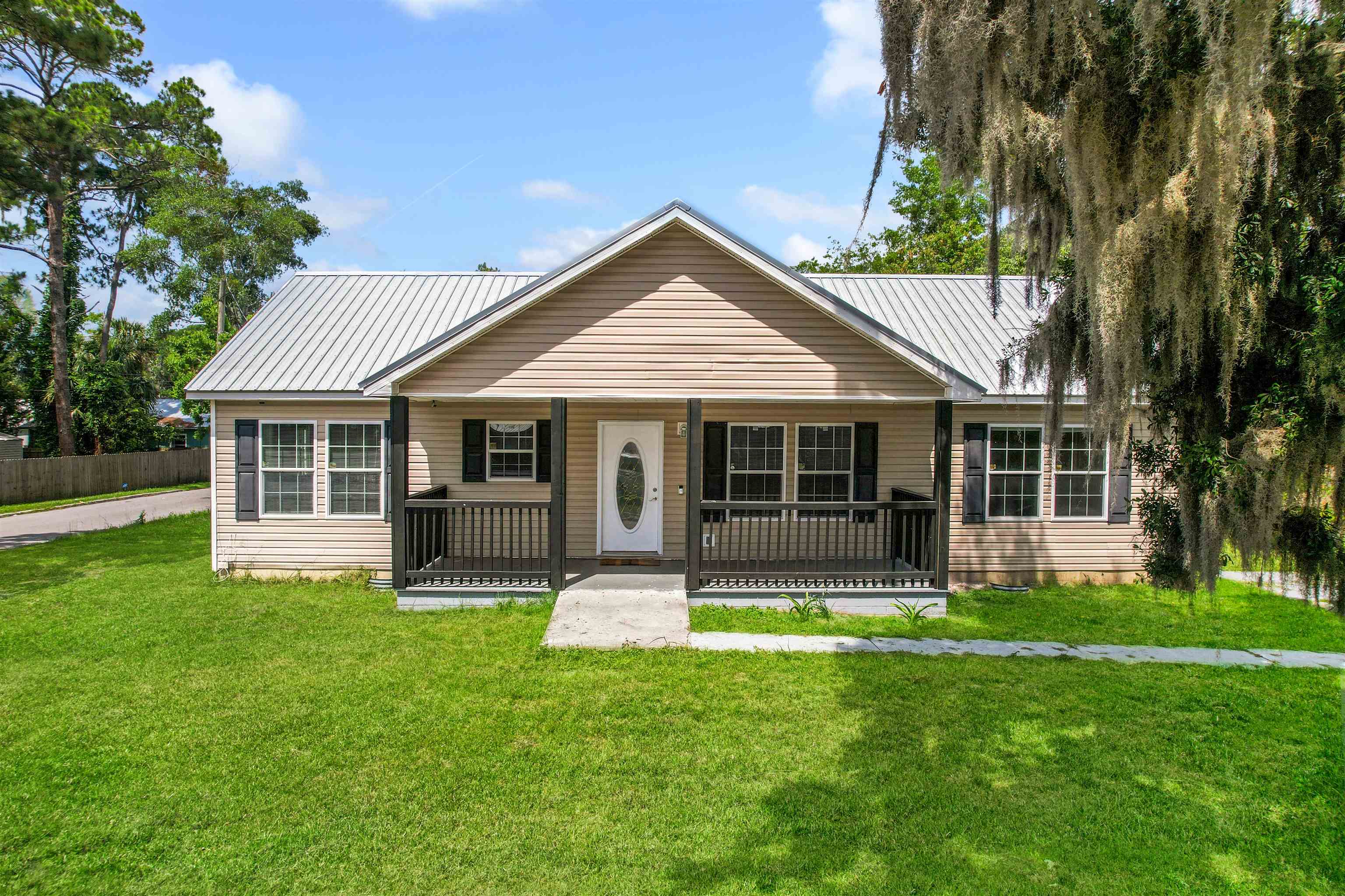 a front view of a house with a yard and porch