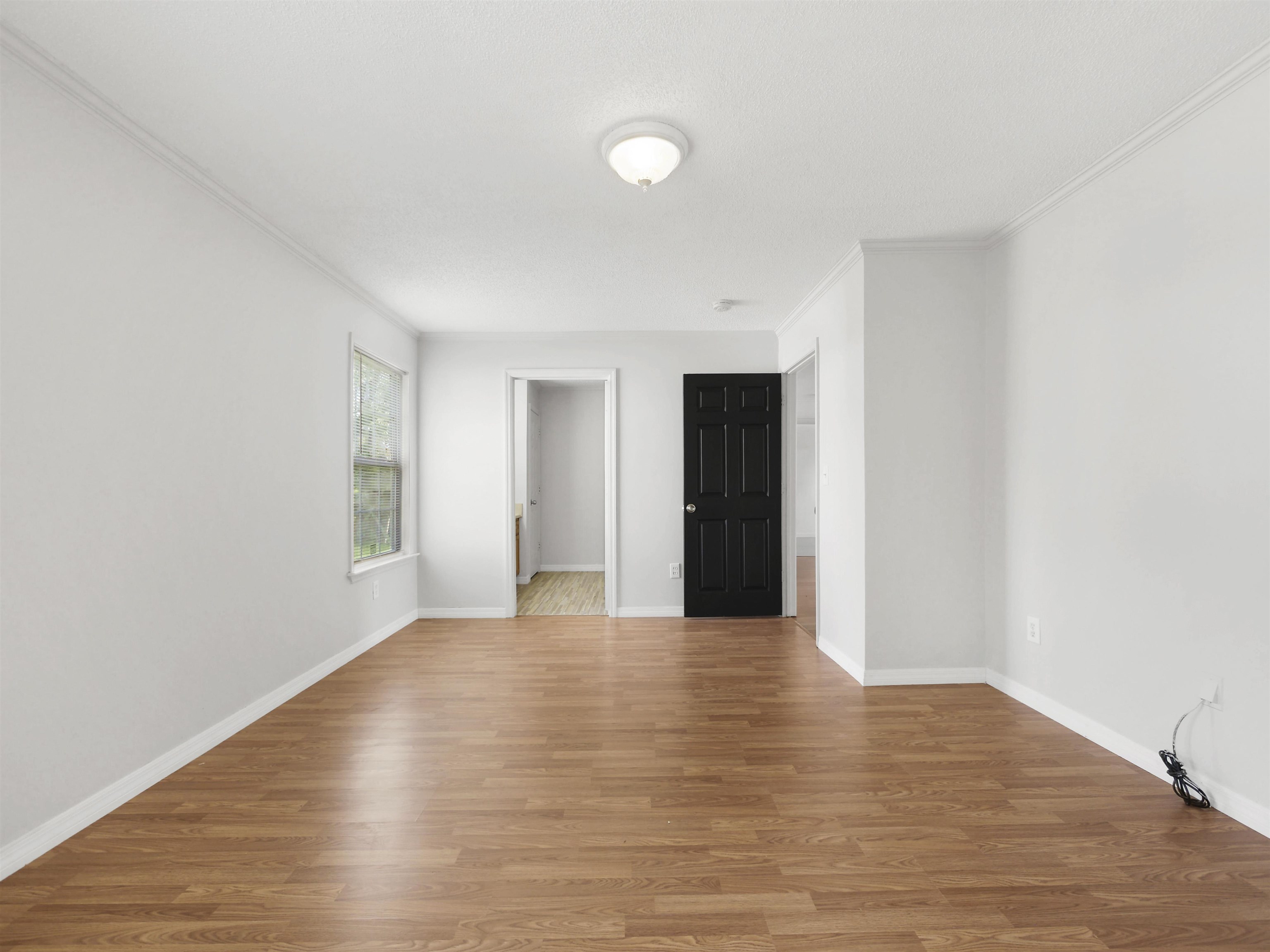 50 Spring Street St. Augustine, FL 32084 - Photo 11 of 30 a view of an empty room with wooden floor and a window