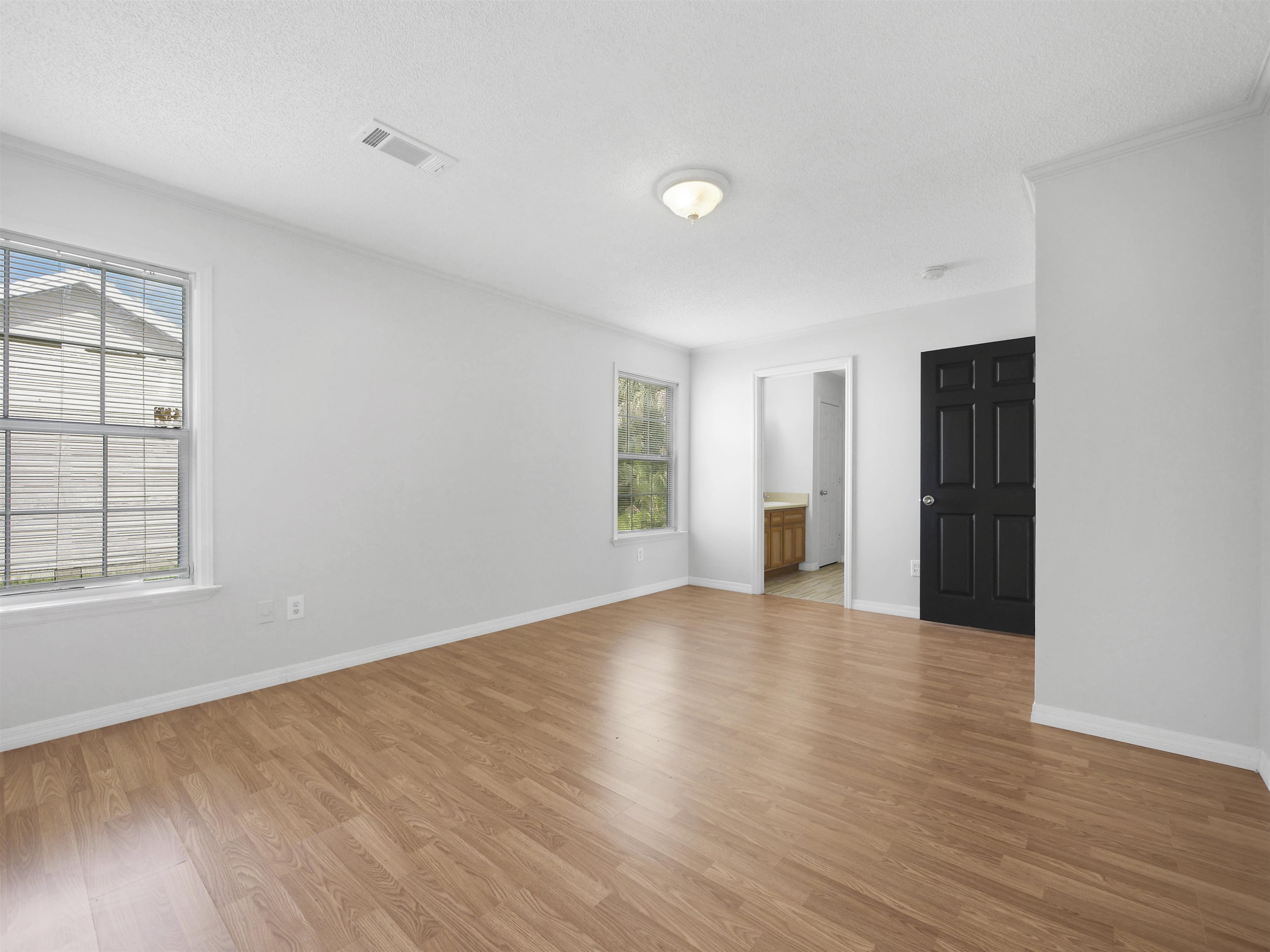 50 Spring Street St. Augustine, FL 32084 - Photo 12 of 30 an empty room with wooden floor and windows