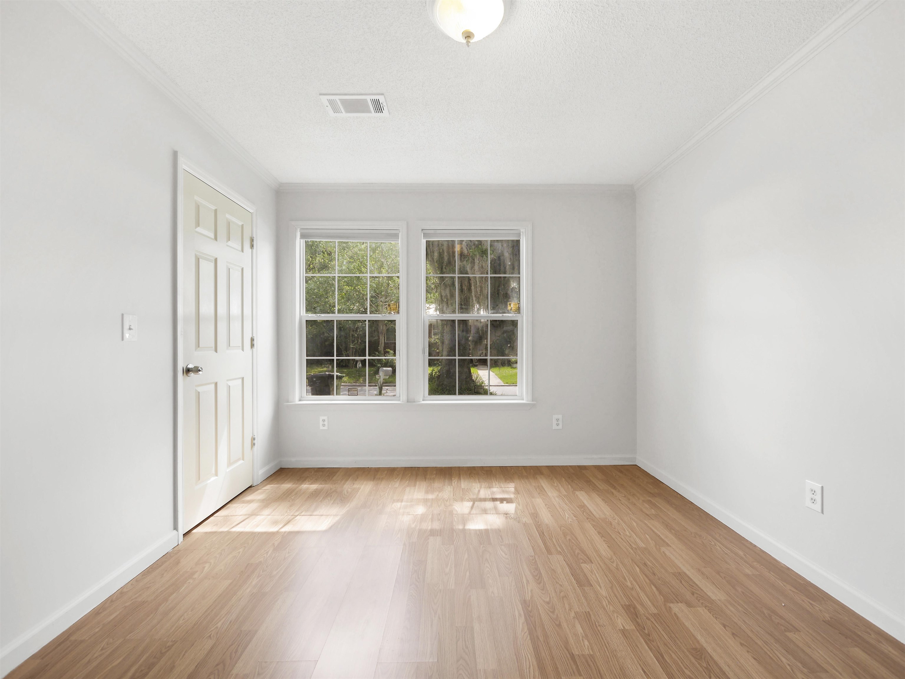 50 Spring Street St. Augustine, FL 32084 - Photo 16 of 30 an empty room with wooden floor and windows