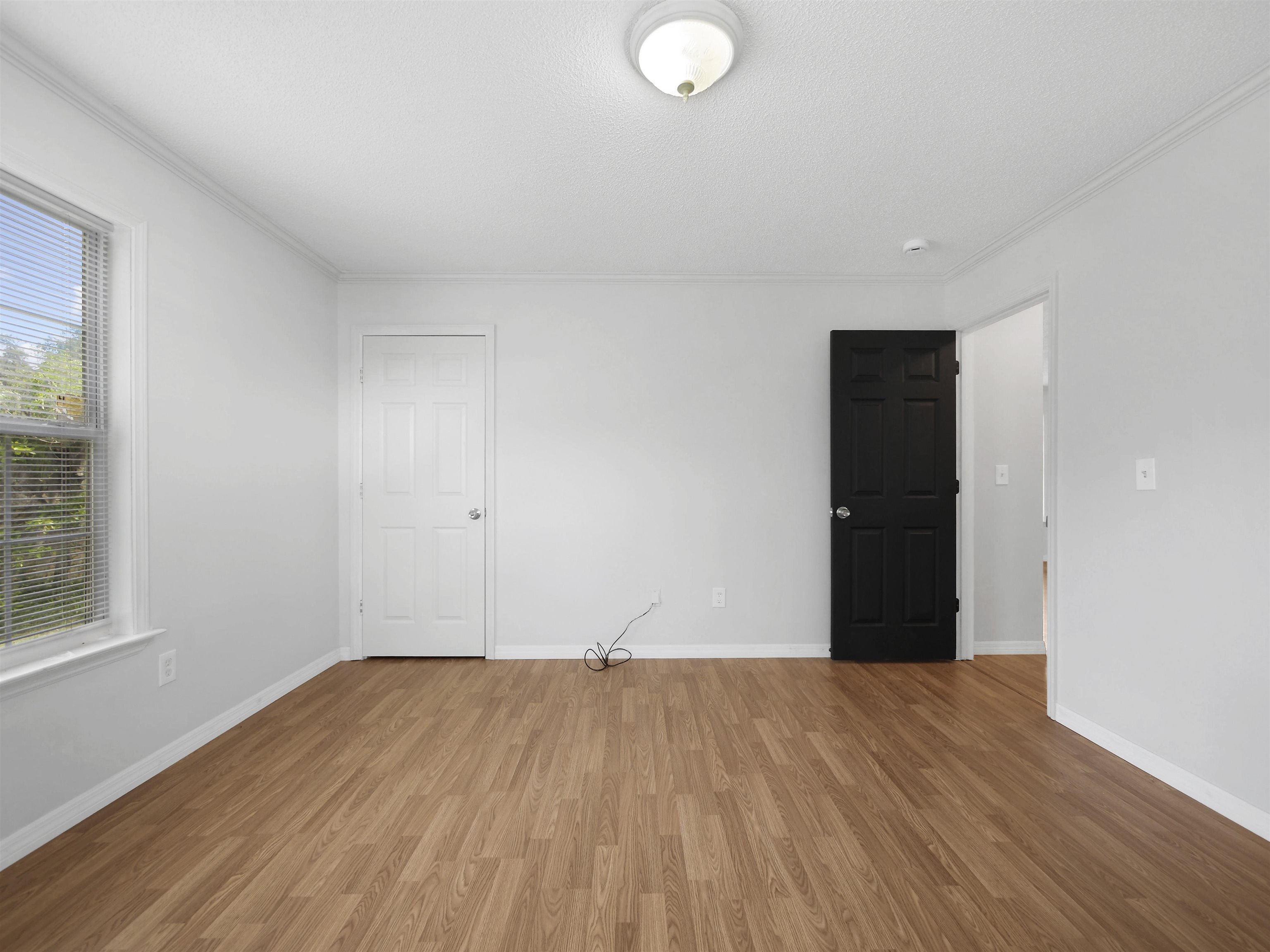 50 Spring Street St. Augustine, FL 32084 - Photo 20 of 30 a view of an empty room with wooden floor and a window