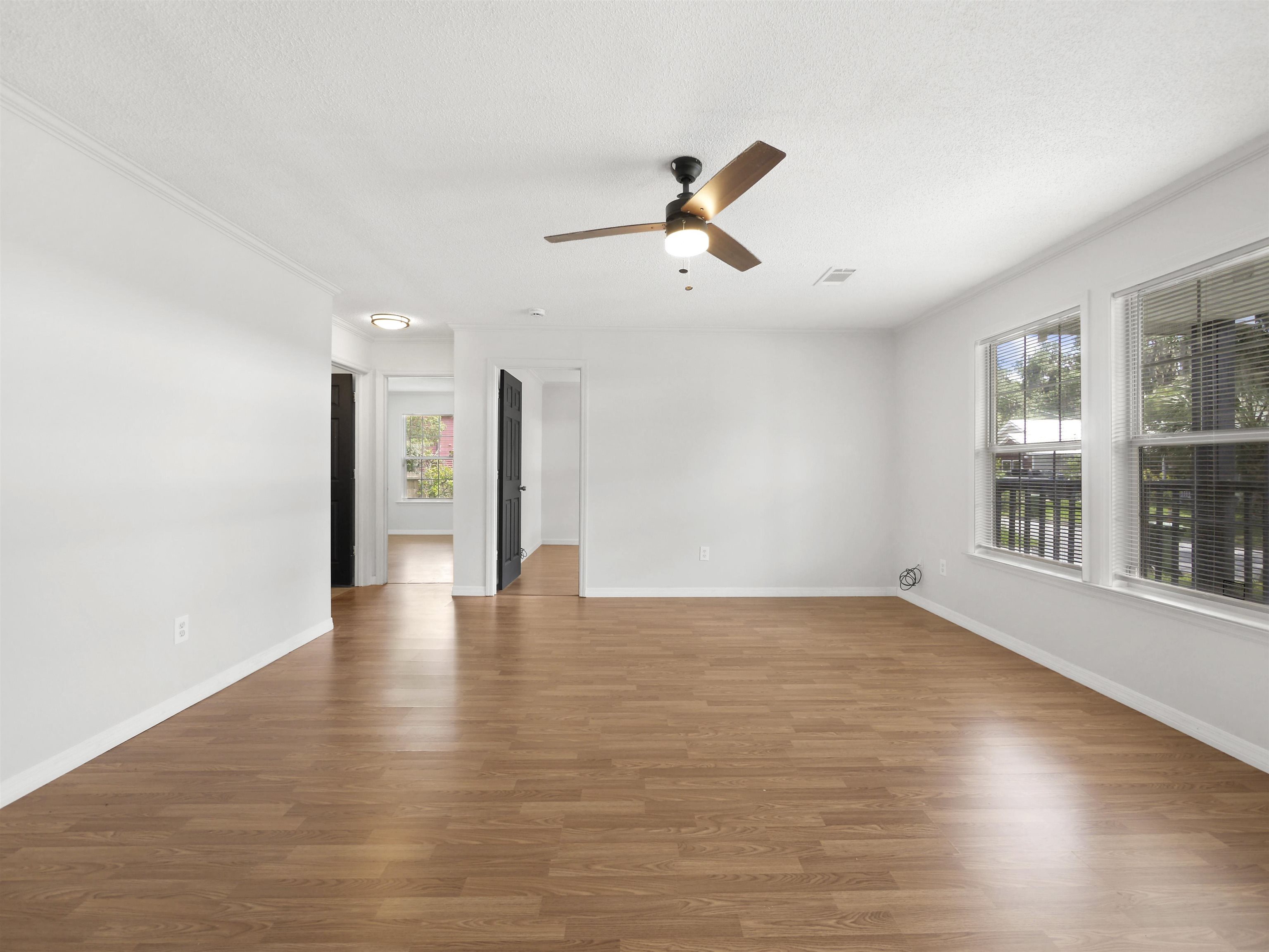 50 Spring Street St. Augustine, FL 32084 - Photo 3 of 30 a view of an empty room with wooden floor and a window