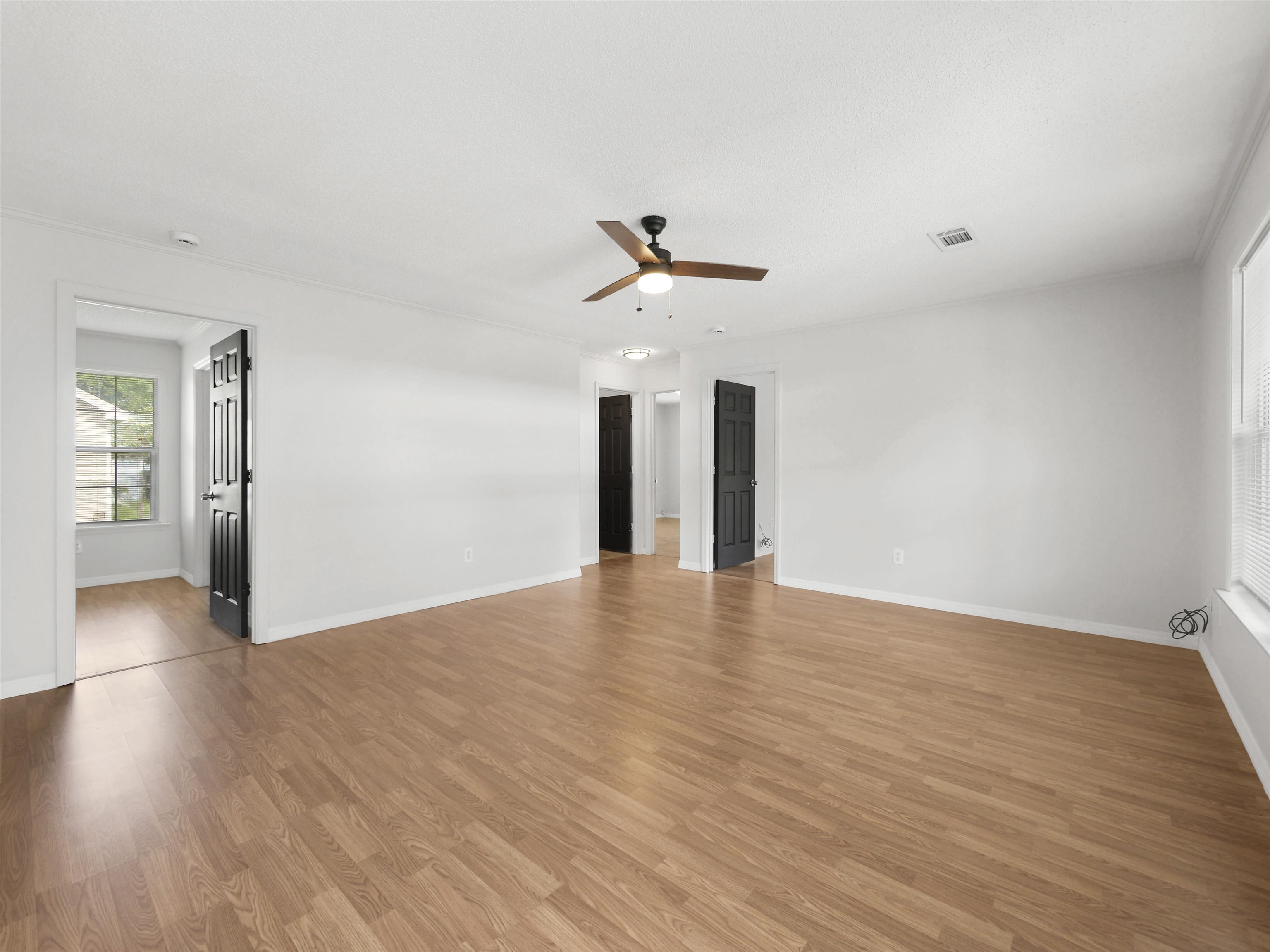 50 Spring Street St. Augustine, FL 32084 - Photo 4 of 30 a view of an empty room with wooden floor and a ceiling fan