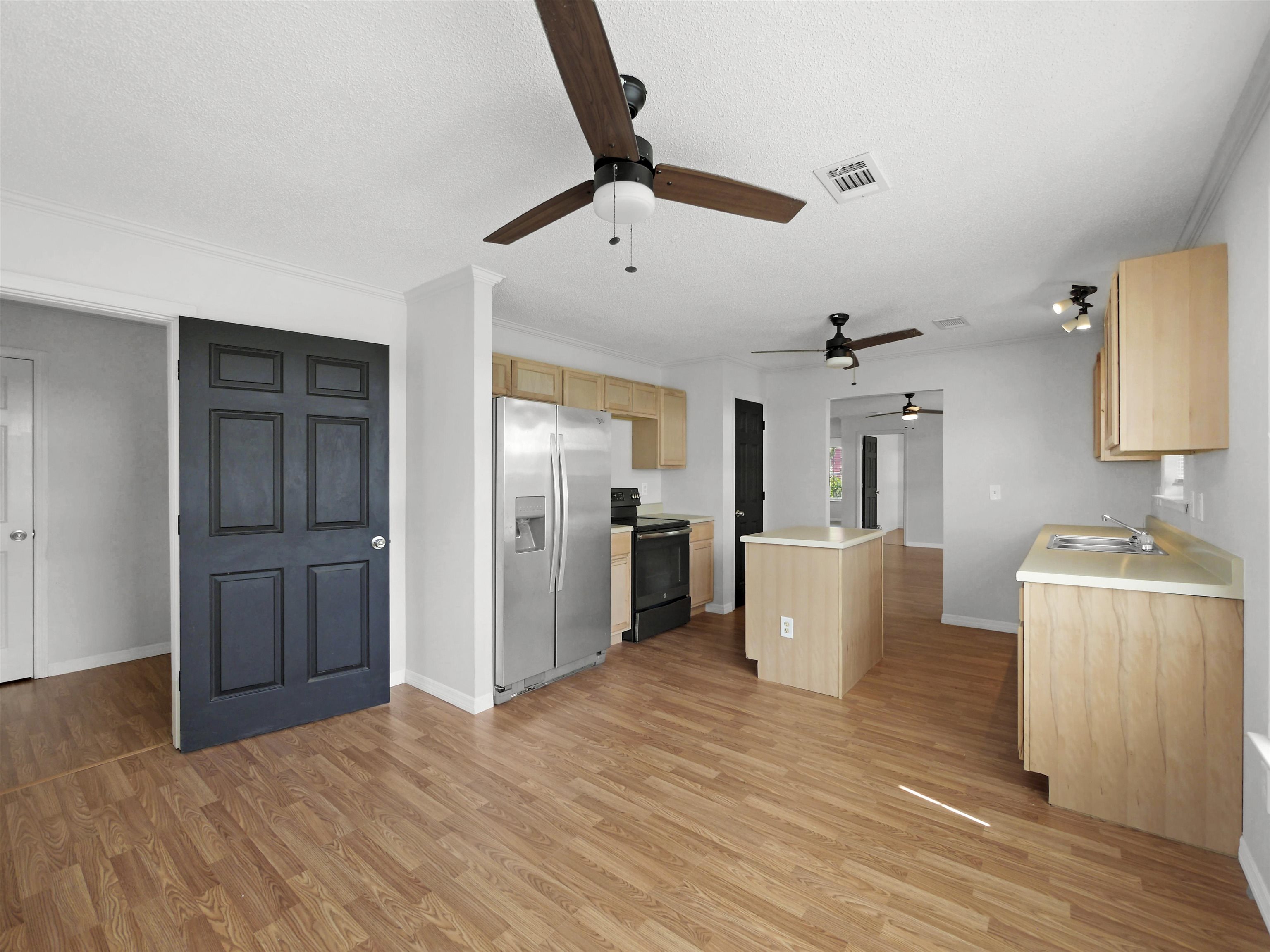 50 Spring Street St. Augustine, FL 32084 - Photo 5 of 30 a view of a kitchen with a sink and a refrigerator