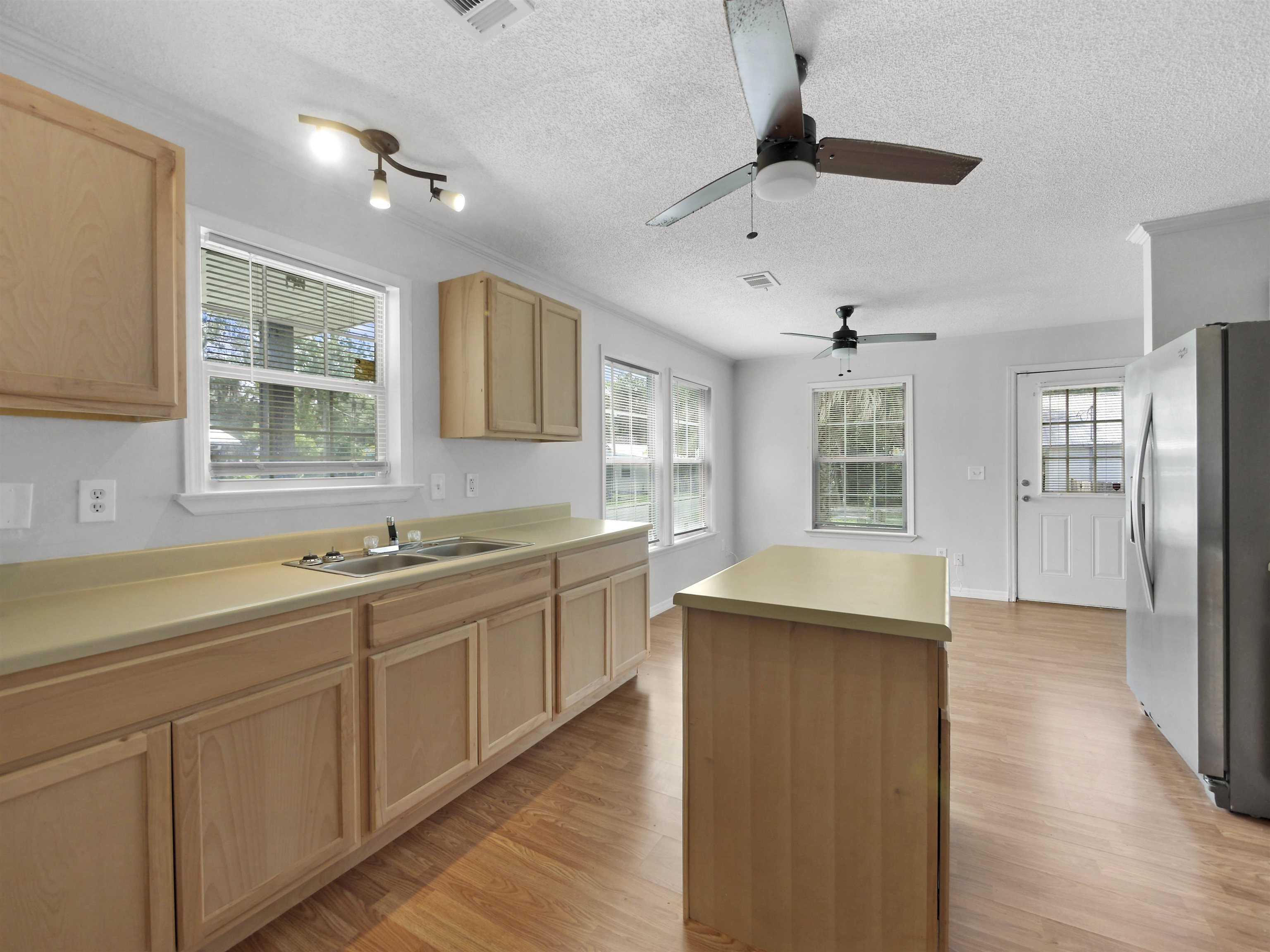 50 Spring Street St. Augustine, FL 32084 - Photo 7 of 30 a kitchen with a sink stove and cabinets