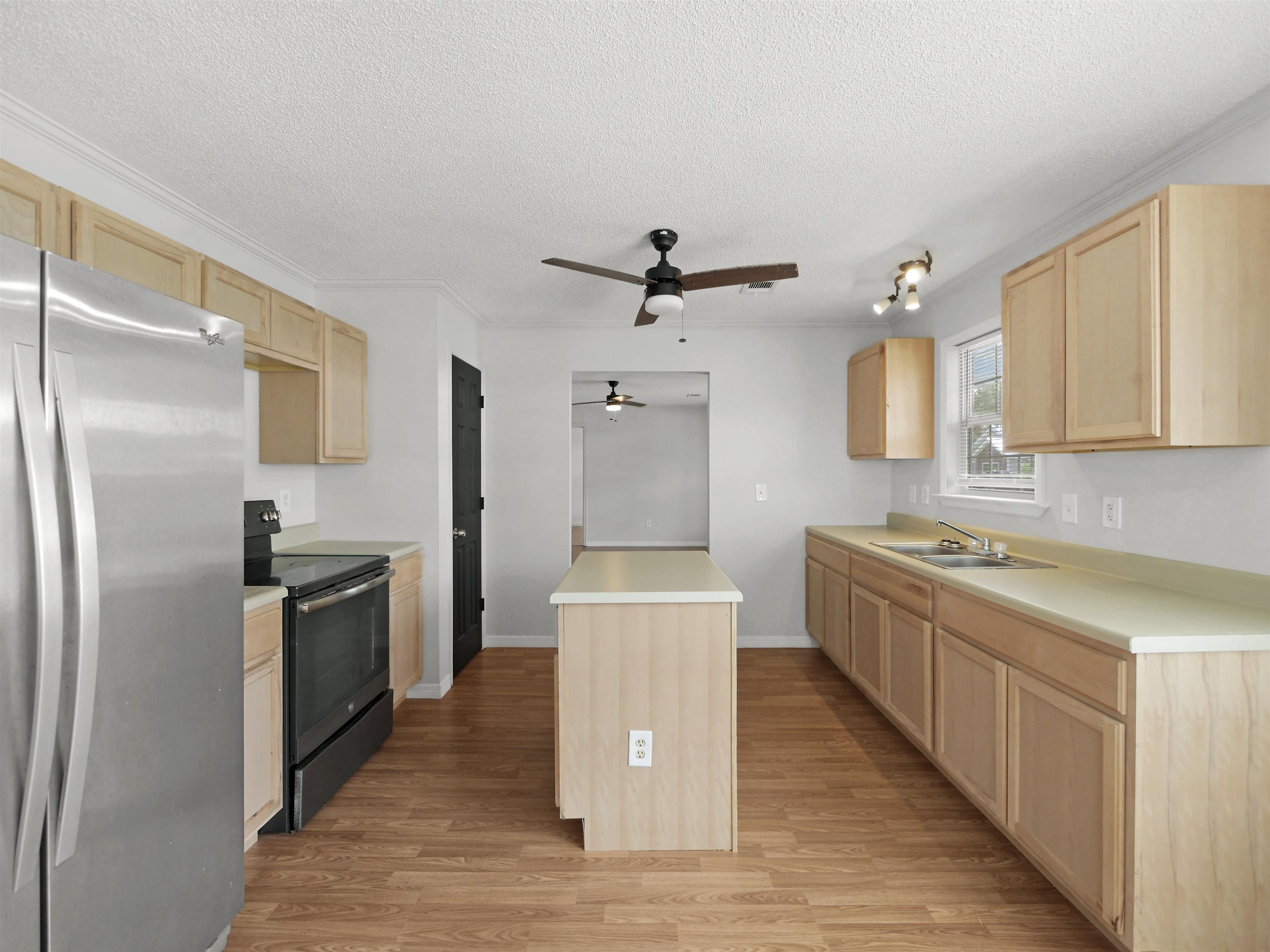 50 Spring Street St. Augustine, FL 32084 - Photo 8 of 30 a kitchen with stainless steel appliances granite countertop a refrigerator a sink dishwasher and a stove with wooden floor