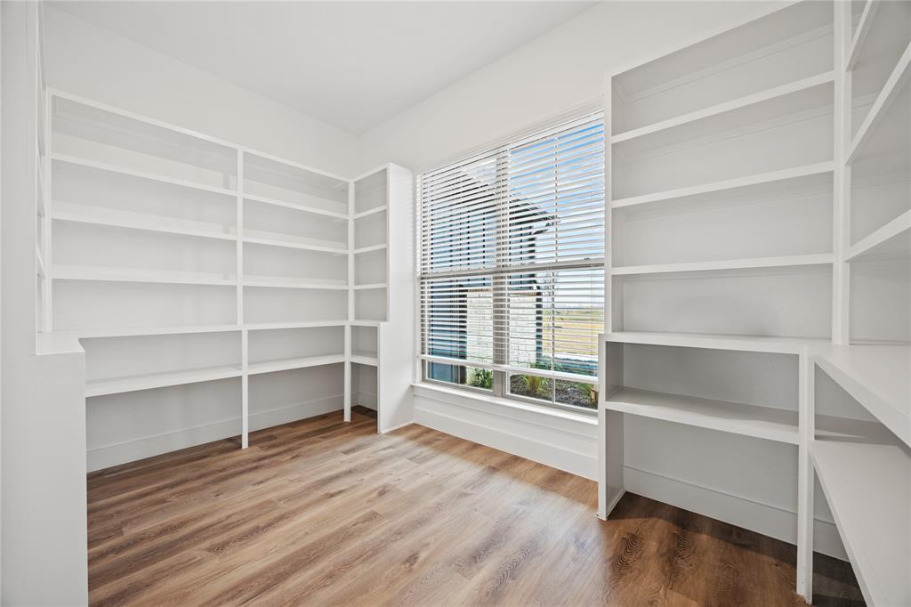 6717 Odom Road Sanger, TX 76266 - Photo 11 of 20 a view of an empty room with a window and wooden floor