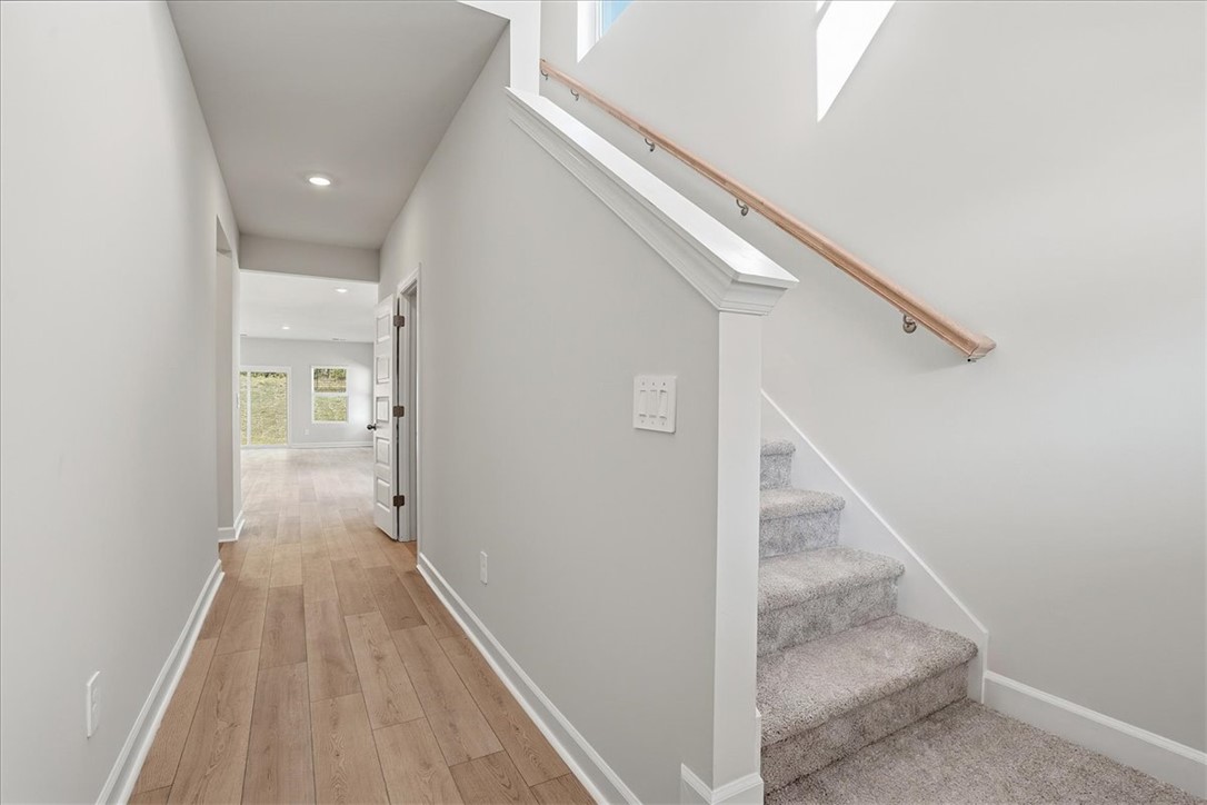 973 Penfold Pointe Point Blythewood, SC 29016 - Photo 5 of 39 A well-lit entryway features a prominent staircase and leads to sun-filled interior spaces.