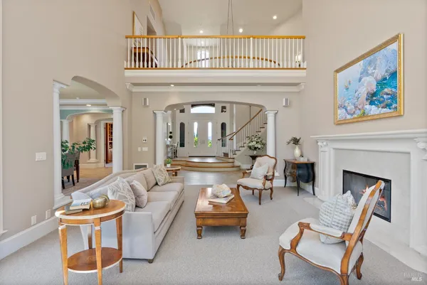 a living room with furniture and large windows