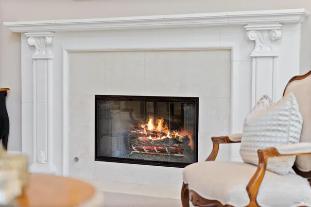a living room with furniture large window and a fireplace