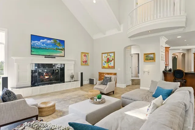 a spacious bedroom with a bed a couch and bookshelf