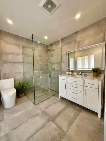 a bedroom with a bed and a potted plant