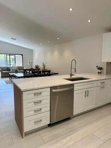 a bathroom with a double vanity sink toilet and shower