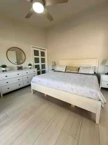 a bed sitting in a room next to a window