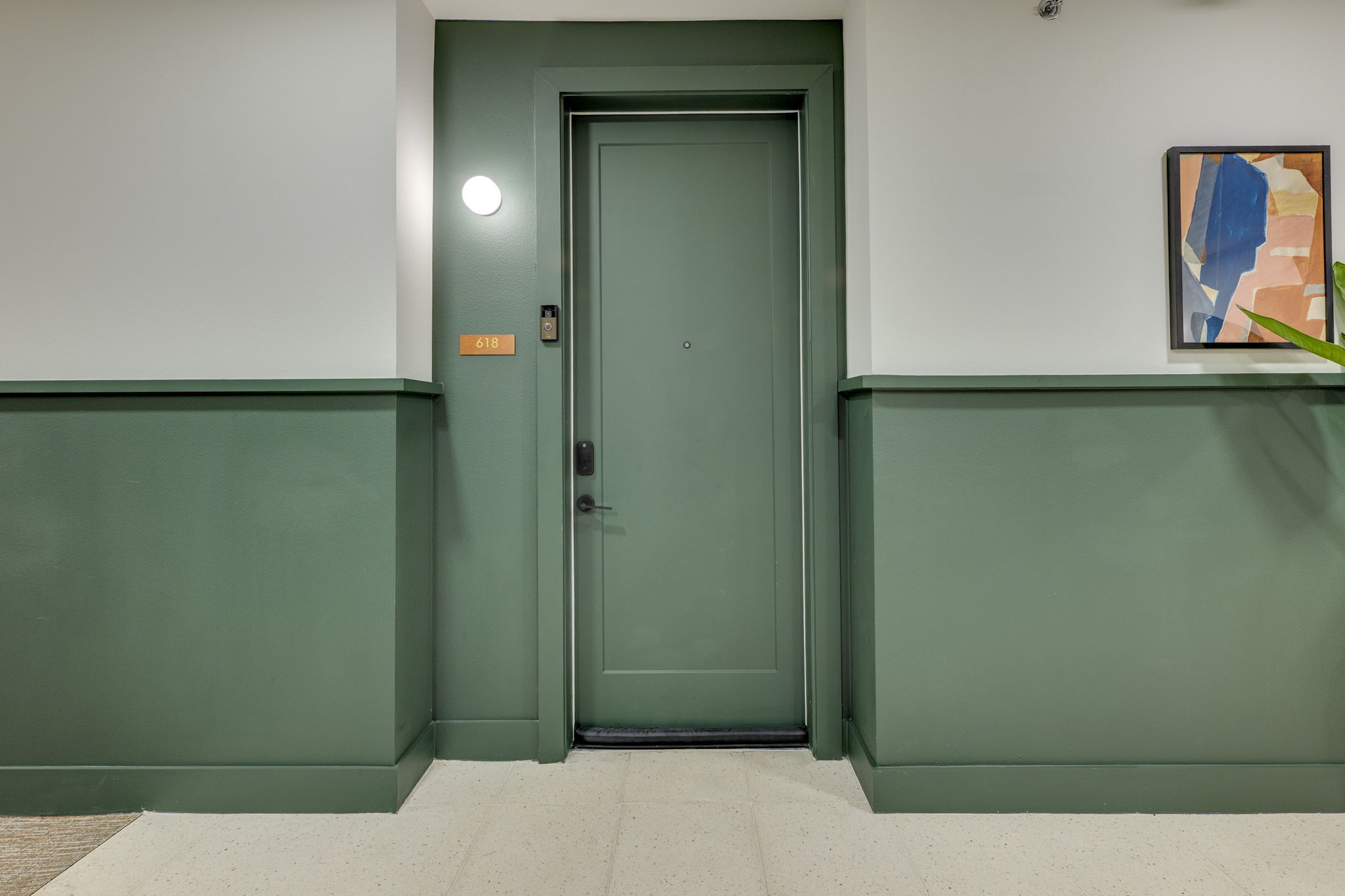 1701 Simond Avenue, Unit 618 Austin, TX 78723 - Photo 14 of 38 The property features a private entrance door with a modern black handle, complemented by a round wall light