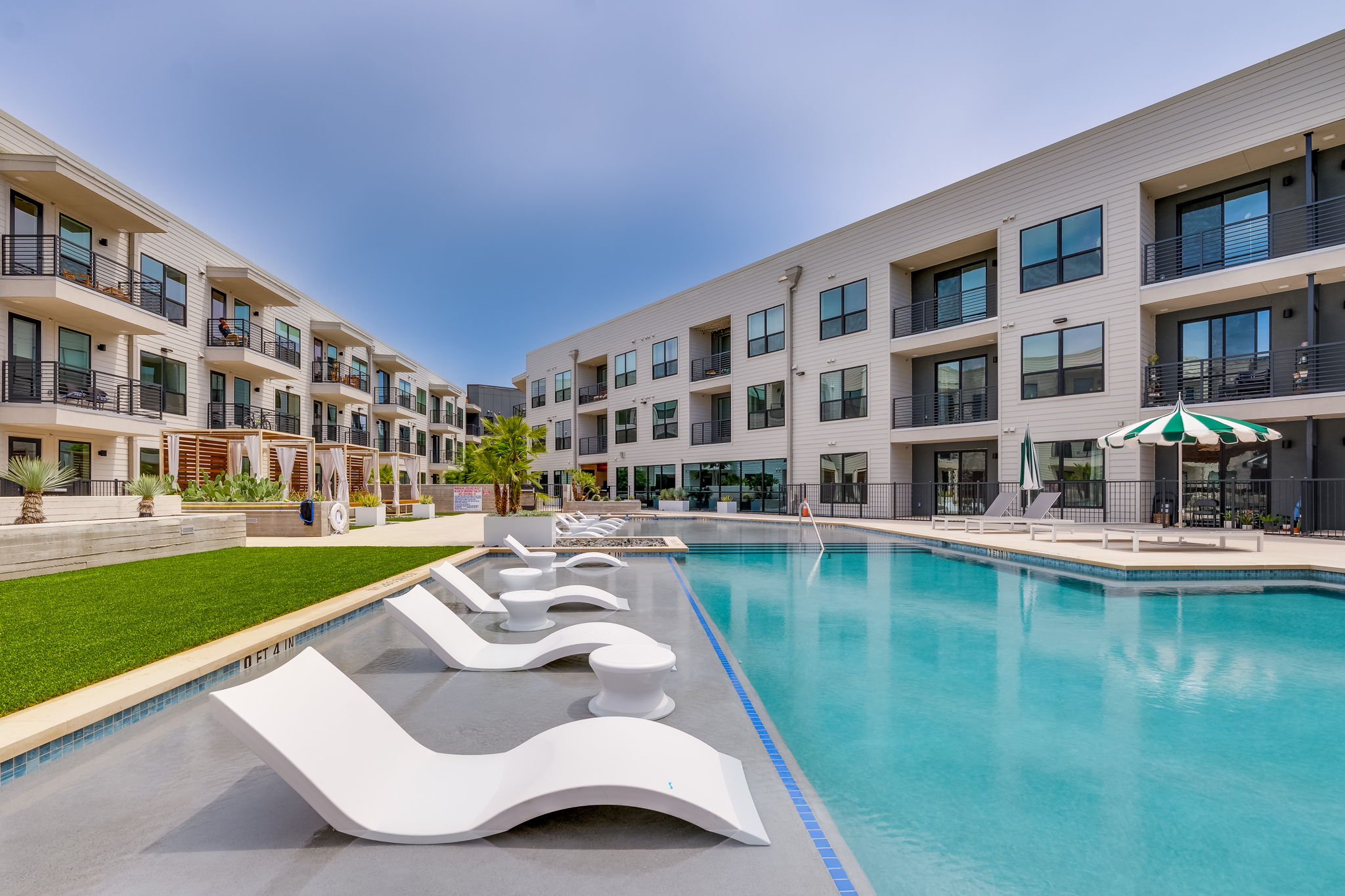 1701 Simond Avenue, Unit 618 Austin, TX 78723 - Photo 23 of 38 A bright and inviting swimming pool is at the center of this property, featuring integrated lounge chairs