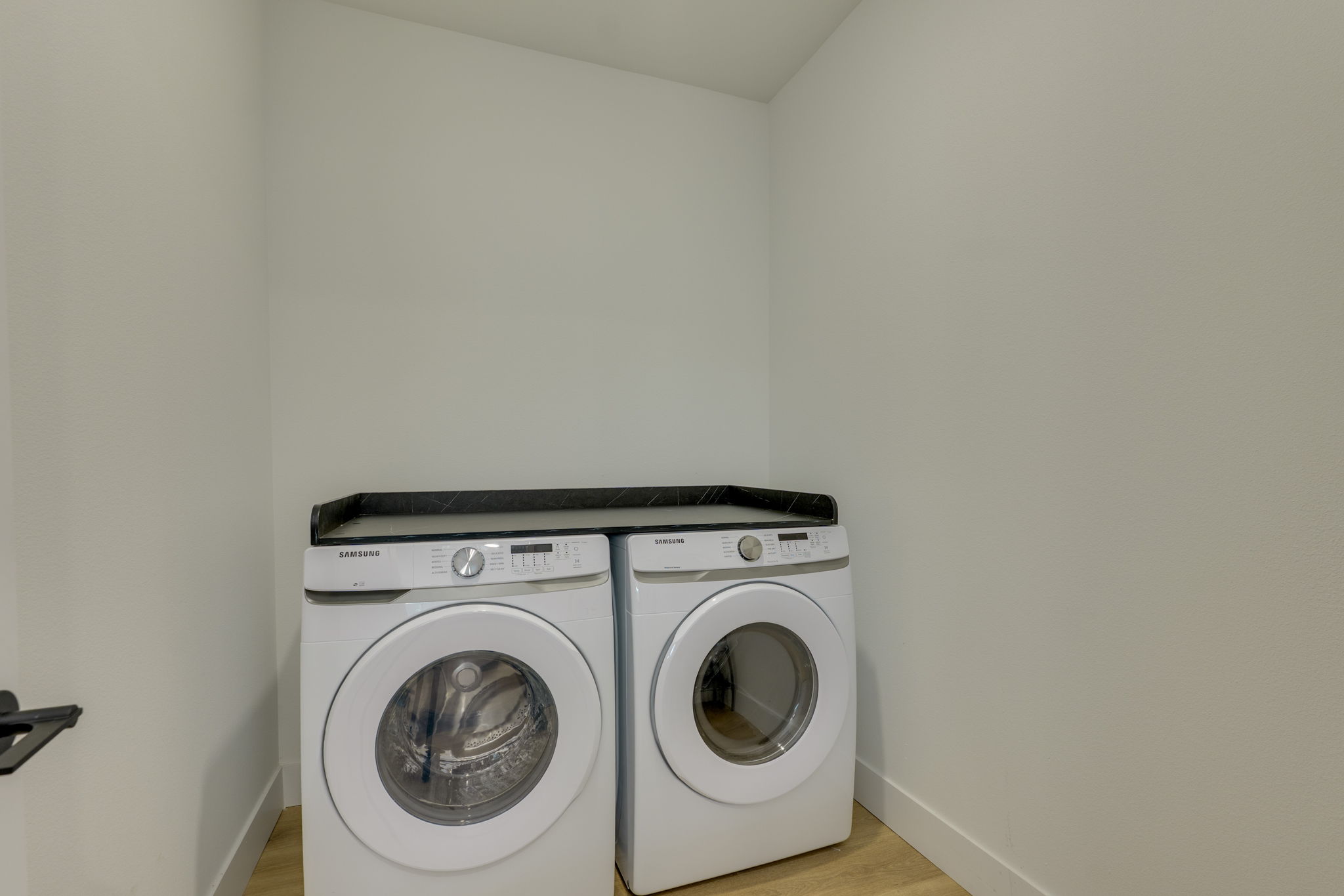1701 Simond Avenue, Unit 618 Austin, TX 78723 - Photo 28 of 38 Dedicated laundry area featuring a front-loading washer and dryer, with a counter space above