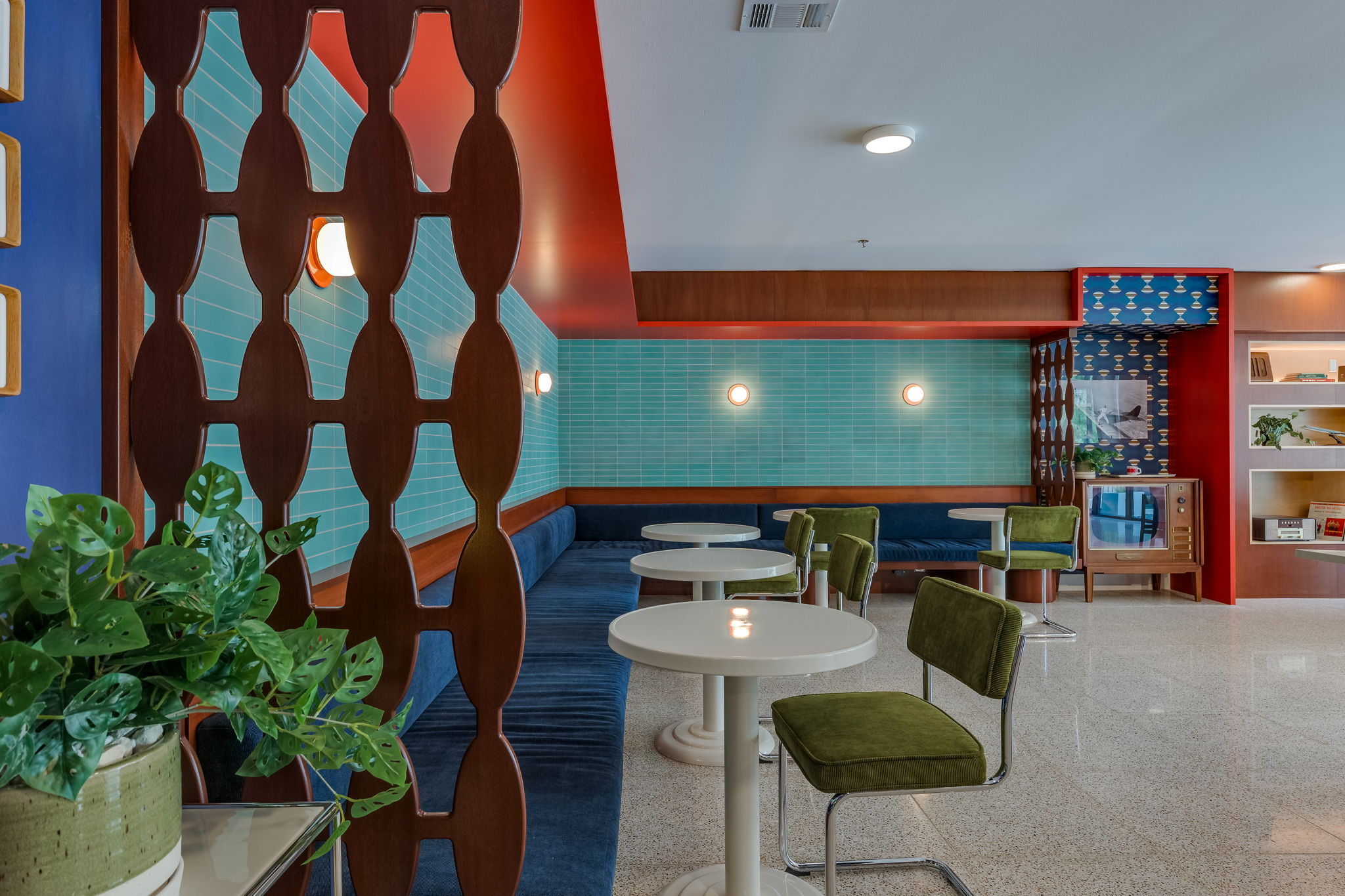 1701 Simond Avenue, Unit 618 Austin, TX 78723 - Photo 30 of 38 Lounge area featuring a long upholstered banquette, a decorative wood room divider, and accent lighting