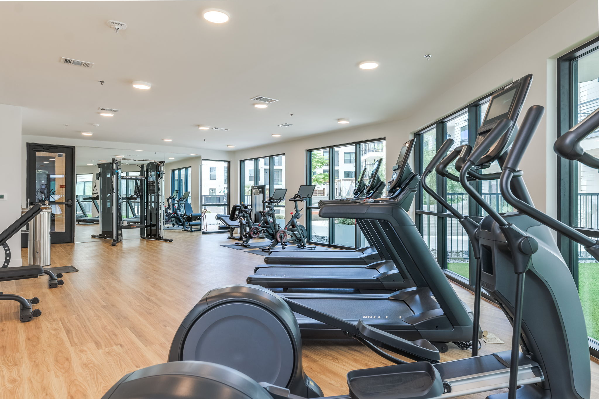1701 Simond Avenue, Unit 618 Austin, TX 78723 - Photo 35 of 38 Fitness center featuring wood flooring and a wall of windows providing natural light