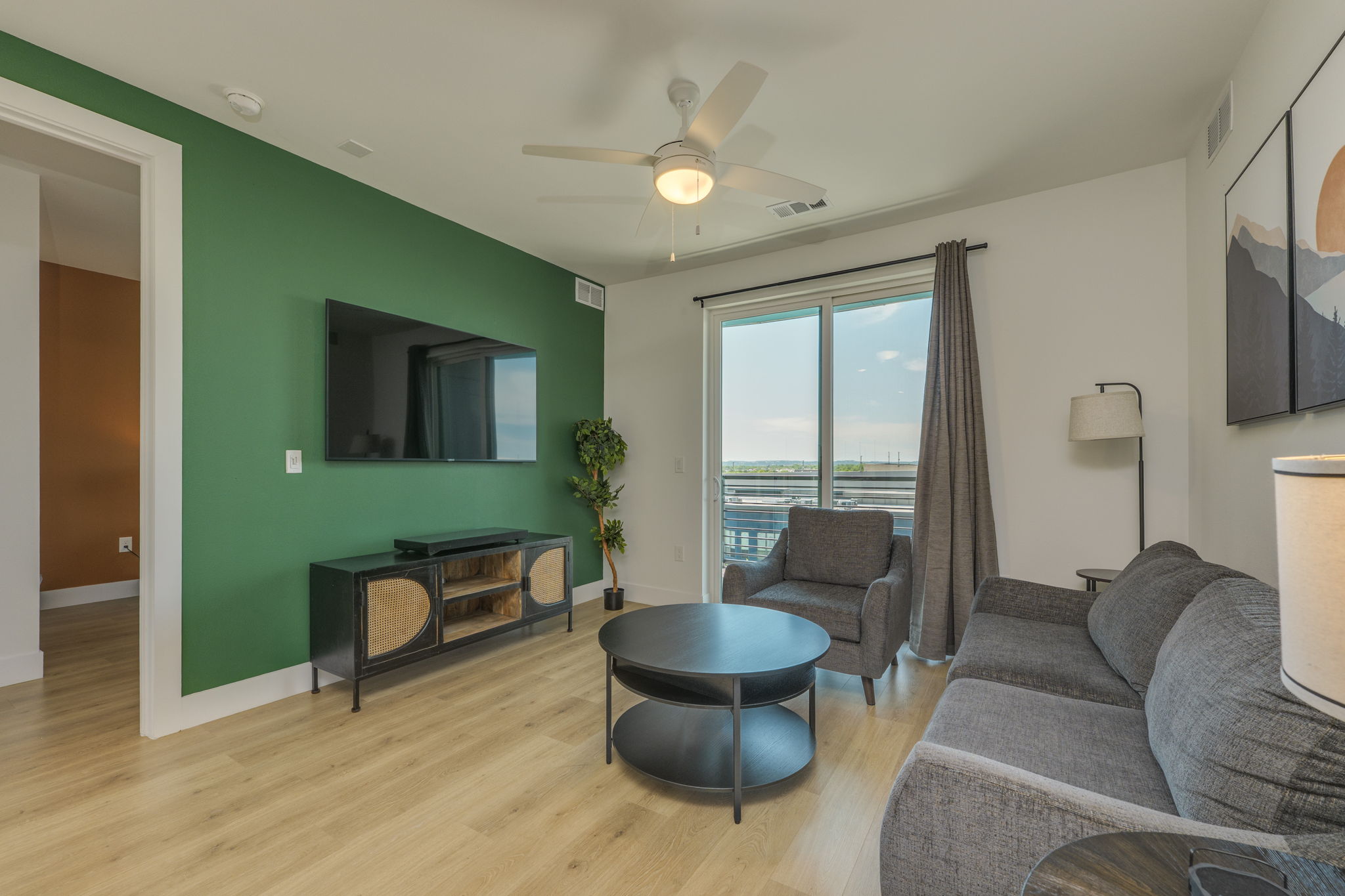 1701 Simond Avenue, Unit 618 Austin, TX 78723 - Photo 6 of 38 The living area features light wood flooring and a bold accent wall