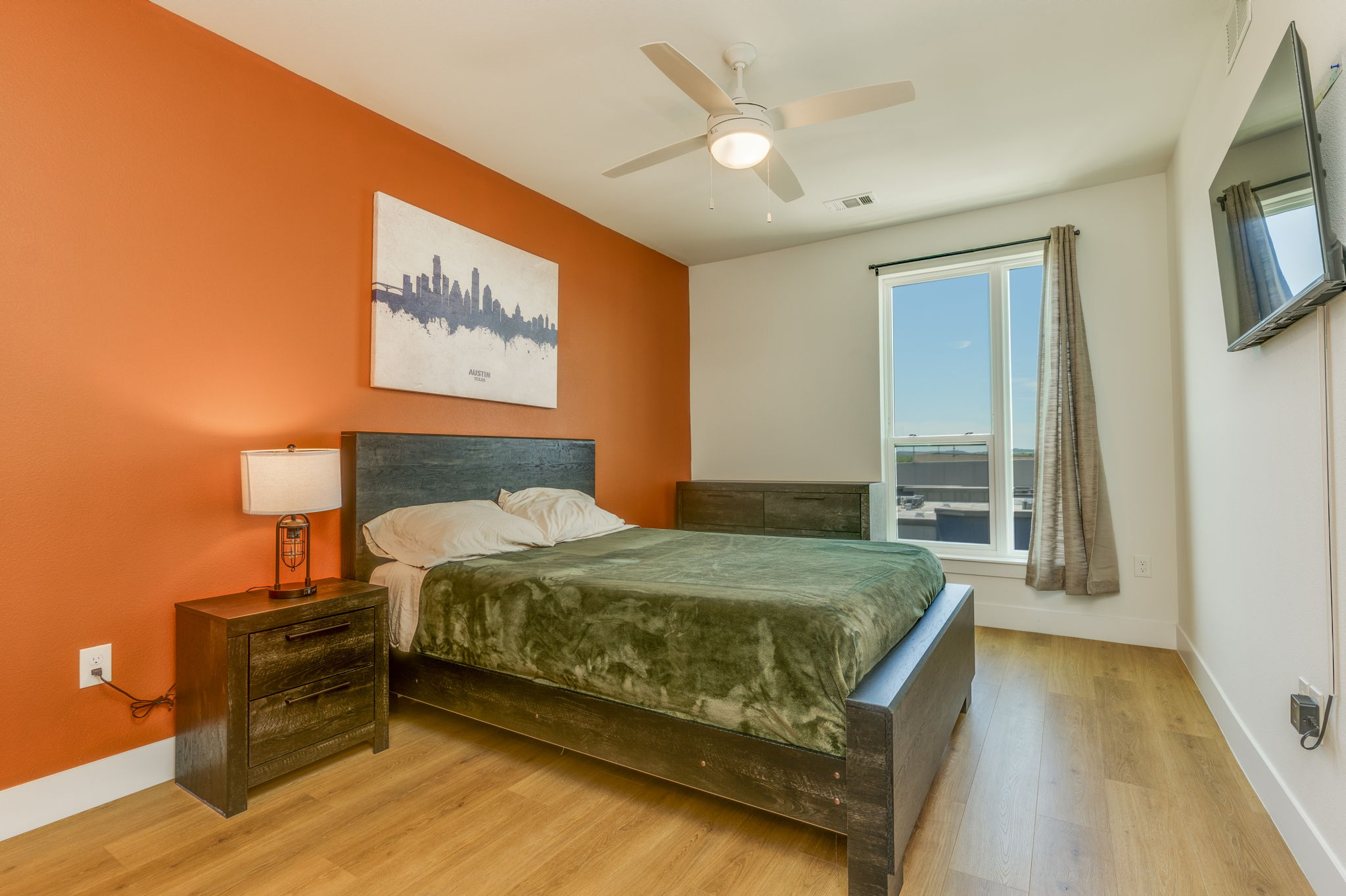 1701 Simond Avenue, Unit 618 Austin, TX 78723 - Photo 9 of 38 This bedroom features a ceiling fan, a window with a view, and light-toned flooring