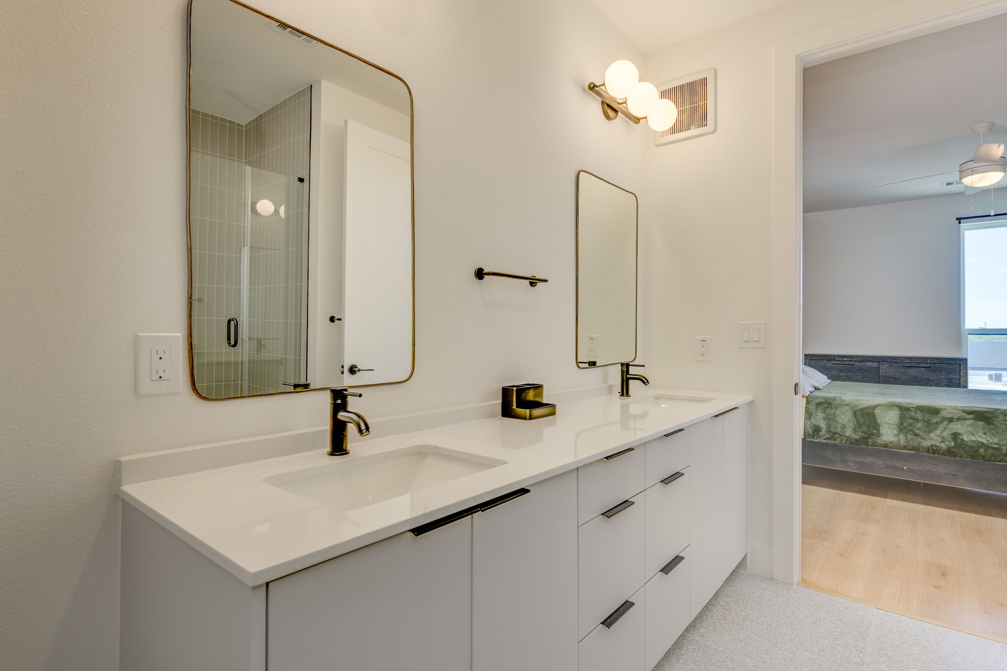 1701 Simond Avenue, Unit 618 Austin, TX 78723 - Photo 10 of 38 Modern bathroom featuring a dual vanity with white countertops, matte black faucets, and rectangular mirrors