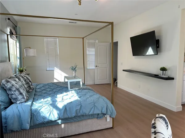 a bedroom with a bed and a flat screen tv