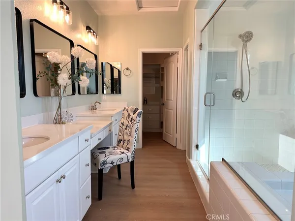 a spacious bathroom with a double vanity sink a mirror and shower