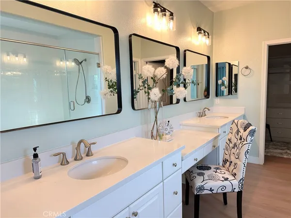 a bathroom with double vanity sink and a mirror