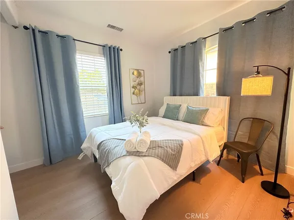 a bedroom with a bed chair and window