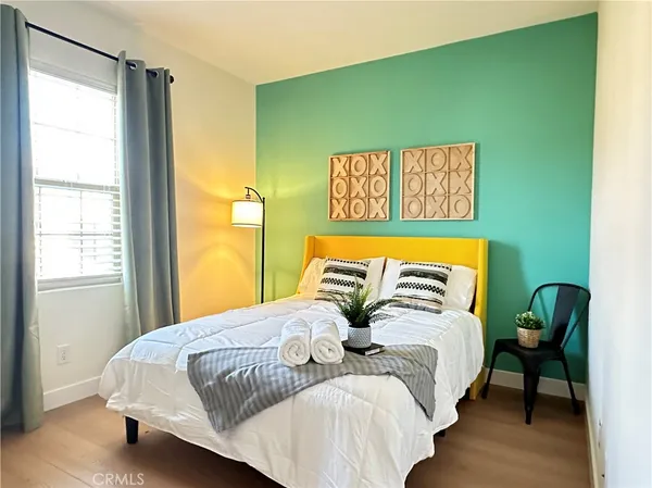 a bedroom with a bed and a window