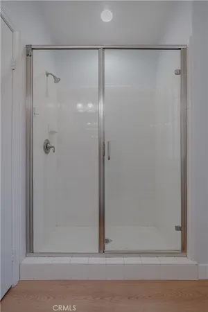 a bathroom with a glass shower door